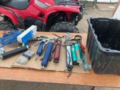 TOTE, several grease guns, grease, cork  gasket material, friction sway bar, booster cables, filter 