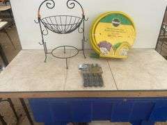 Unused 50' garden hose, ornamental iron plant stand, unused steak knives