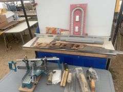 Post pounder, axe, quantity of hand saws, levels, hand mitre saw, trowels etc.