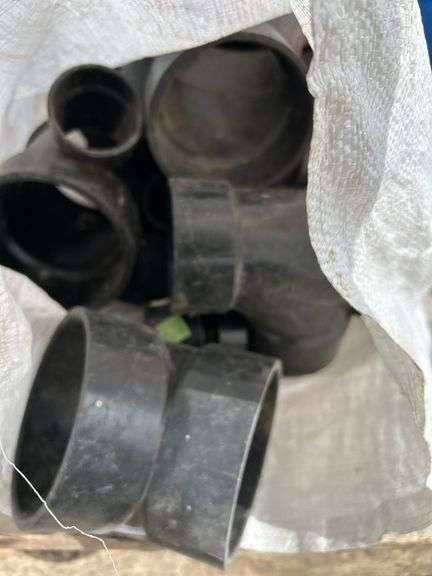 Pallet of misc black poly pipe fittings, garden hose, sewer snake