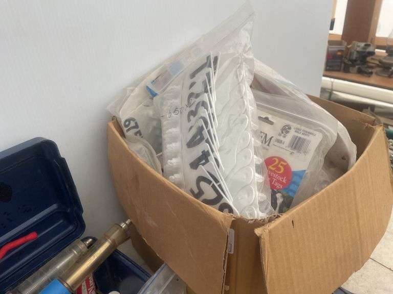 Large quantity of ear tags  and installer pliers, vaccination syringes