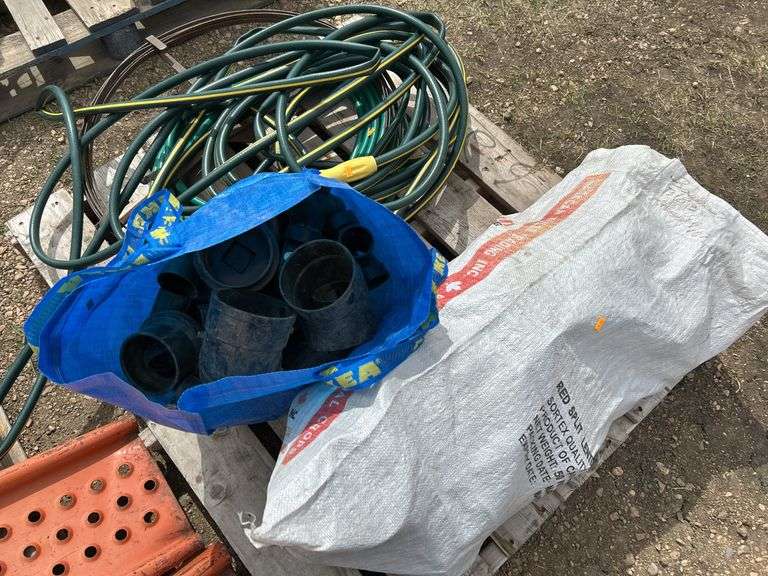 Pallet of misc black poly pipe fittings, garden hose, sewer snake
