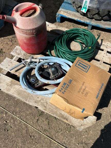 Pallet with garden hose, fuel nozzle hose, tail lights, and gas can