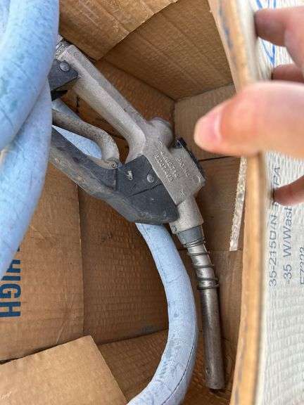 Pallet with garden hose, fuel nozzle hose, tail lights, and gas can