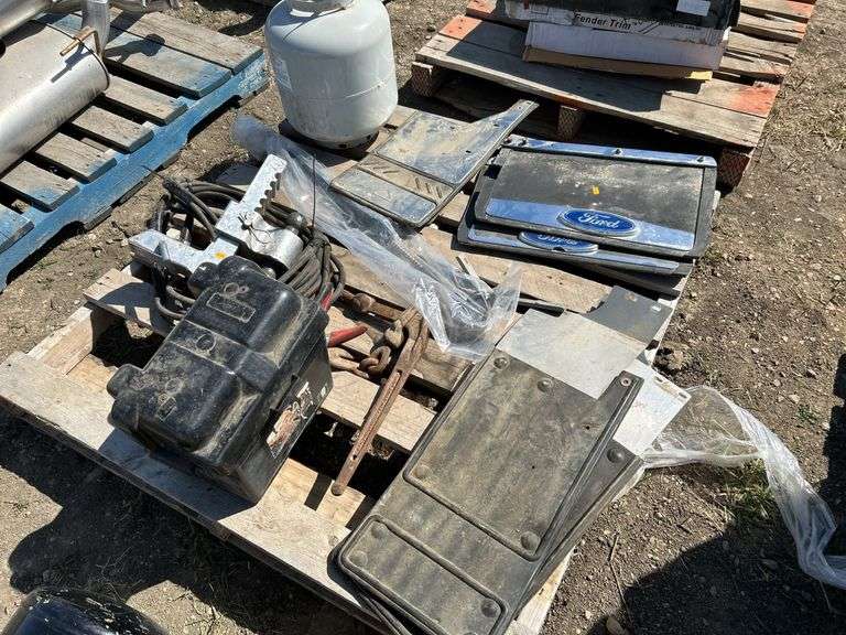 Pallet with mud flaps with battery box, booster cables, ball reciever, propane tank etc.