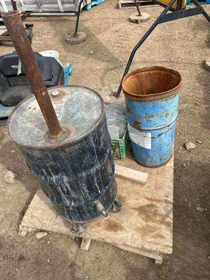 Pallet with 2 steel barrels with drains and milk crate of metal shelving dividers