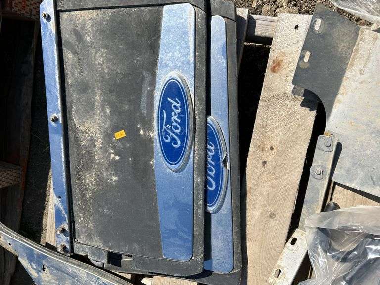 Pallet with mud flaps with battery box, booster cables, ball reciever, propane tank etc.
