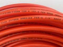 Roll of 1/2" orange pex, quantity of plumbing fittings in metal box