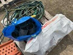 Pallet of misc black poly pipe fittings, garden hose, sewer snake
