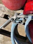 Pallet with garden hose, fuel nozzle hose, tail lights, and gas can