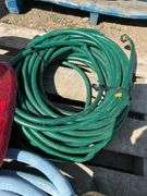 Pallet with garden hose, fuel nozzle hose, tail lights, and gas can