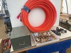 Roll of 1/2" orange pex, quantity of plumbing fittings in metal box