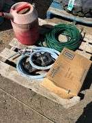 Pallet with garden hose, fuel nozzle hose, tail lights, and gas can