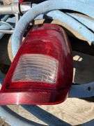 Pallet with garden hose, fuel nozzle hose, tail lights, and gas can