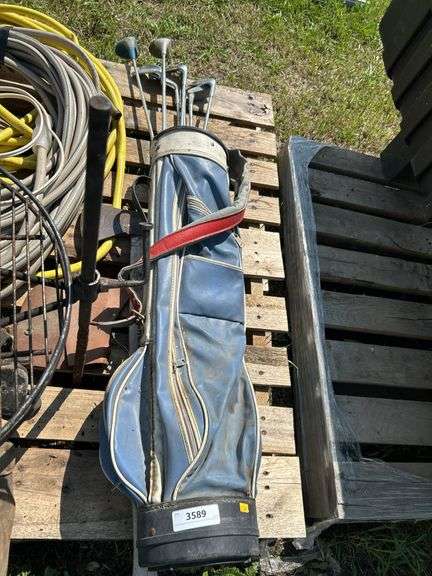 Pallet with golf clubs, garden hose, climbing spikes ets