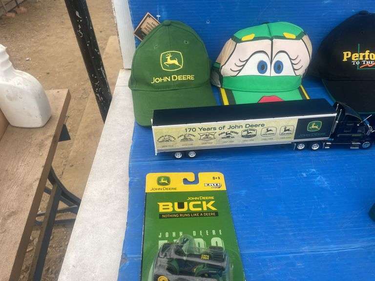 Quantity of John Deere caps including one that is autographed by "Chad Little", also paperweight and