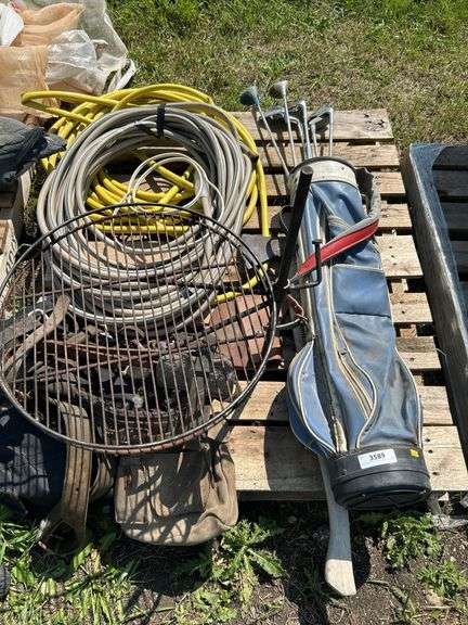Pallet with golf clubs, garden hose, climbing spikes ets