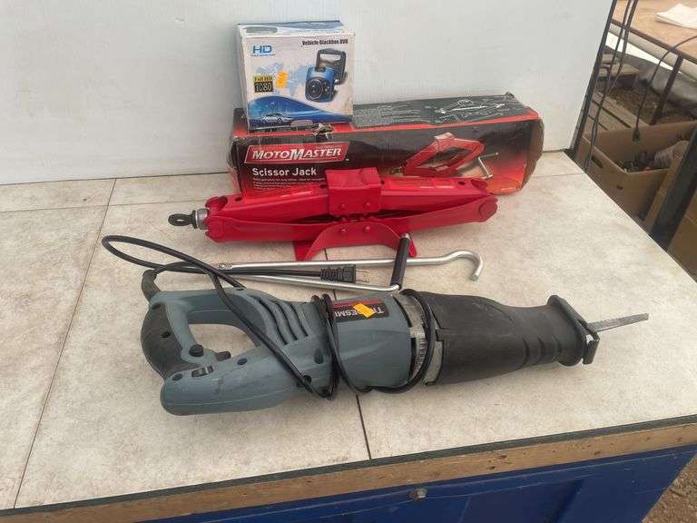 MotoMaster scissor jack, Vehicle Blackbox DVR, and a TradeSmith reciprating saw