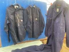 2 Flame resistant shirts size medium and a pair of coveralls-54T
