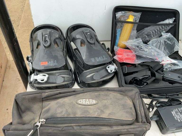 Pair of snowboarding bindings, gears, handlebar bag, Coleman camp stove, garment bag, miscellaneous