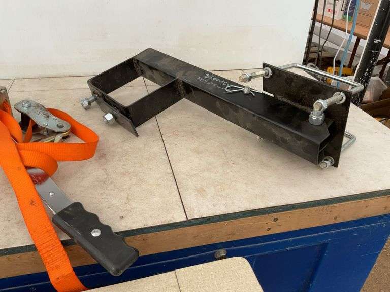 Ratcheting strap, spare tire carrier