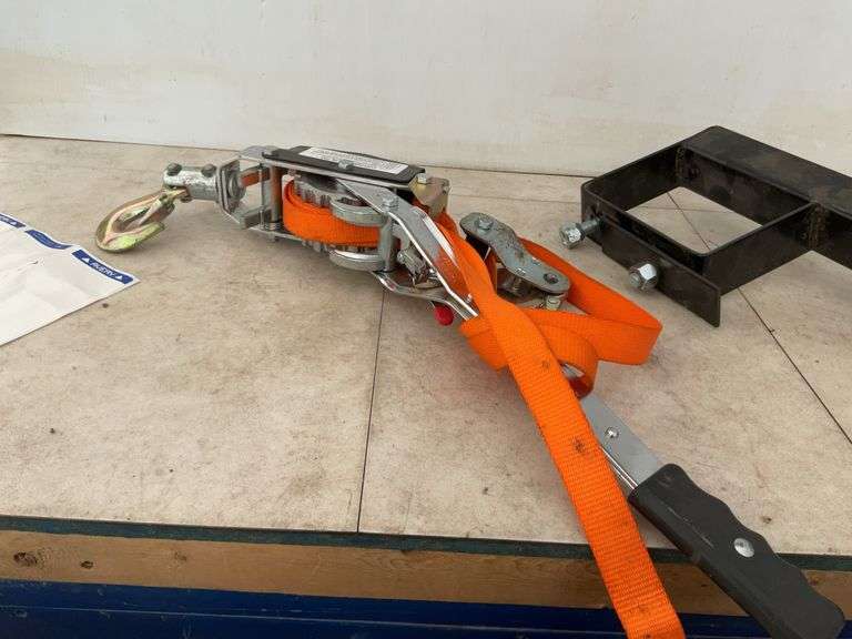 Ratcheting strap, spare tire carrier