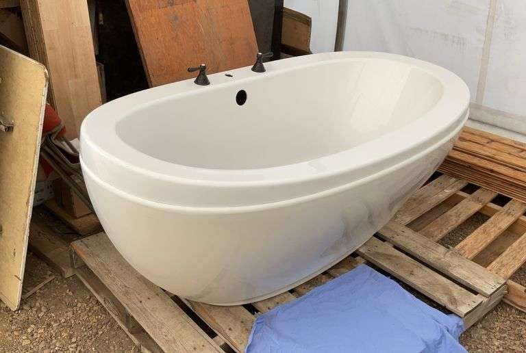 Oval shape bathtub measures 66"overall length, 36" overall width, comes with taps