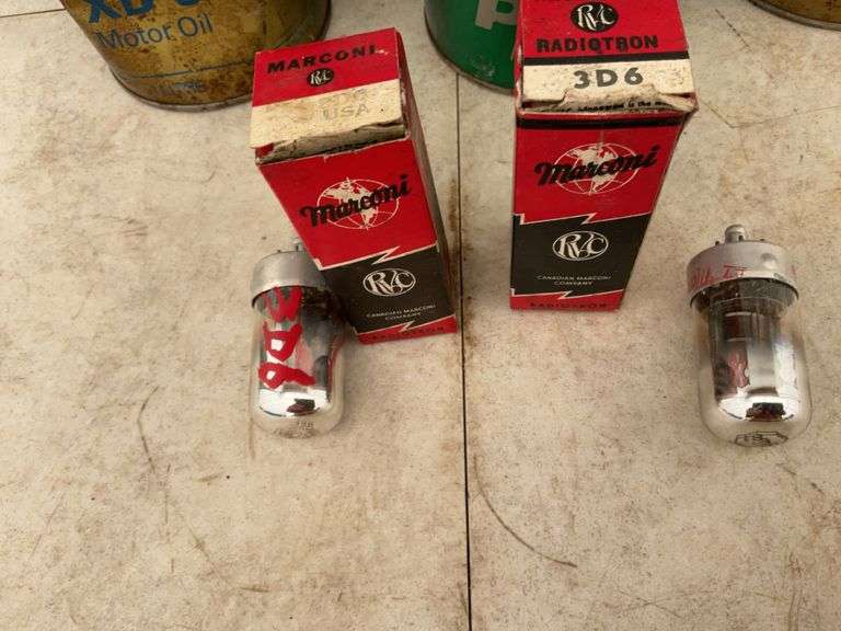 3 Esso oil tins with oil in them, cans are dented, also 2 Marconi 3-D six tubes