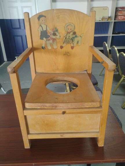 Vintage wooden potty chair with illustrations of a little boy and girl and their puppies on back re