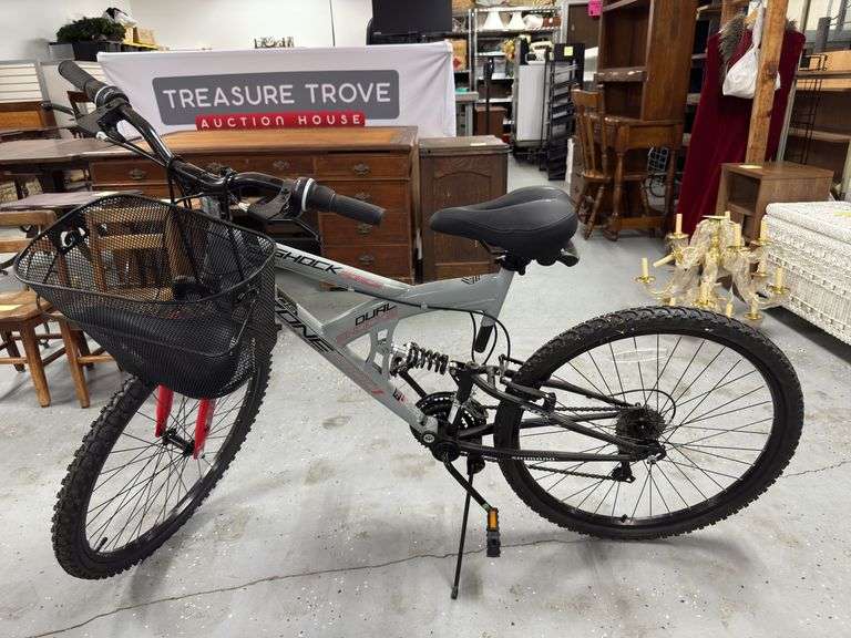 Shimano mountain bike with shocks. Should be 21 speed. Basket on front. Extra seat included.