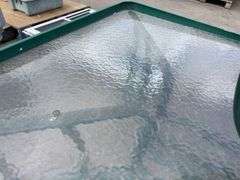 Outdoor Glasstop table and Plastic Stacker Chairs