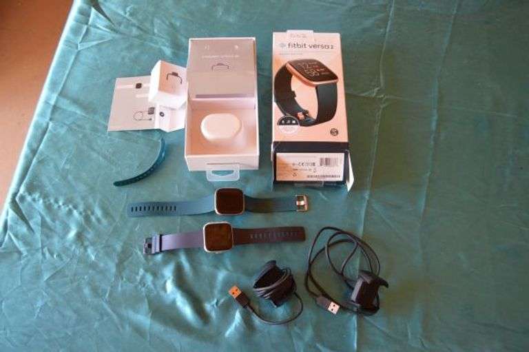 FITBIT VERSAS WITH CHARGERS.  THEY LIGHT UP WHEN PUT ON CHARGER