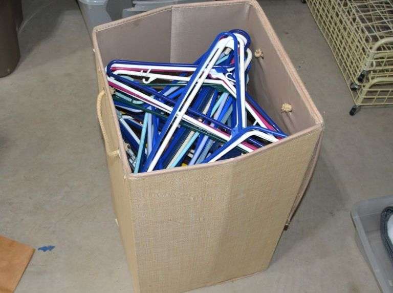 BASKET FULL OF PLASTIC HANGERS