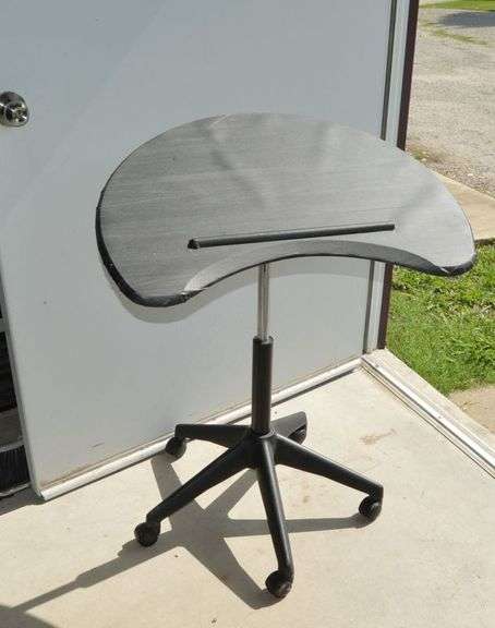 ADJUSTABLE ROLLING DESK. THERE IS A LAMINATE COVERING THAT LOOKS LIKE IT CAN BE PEELED OFF