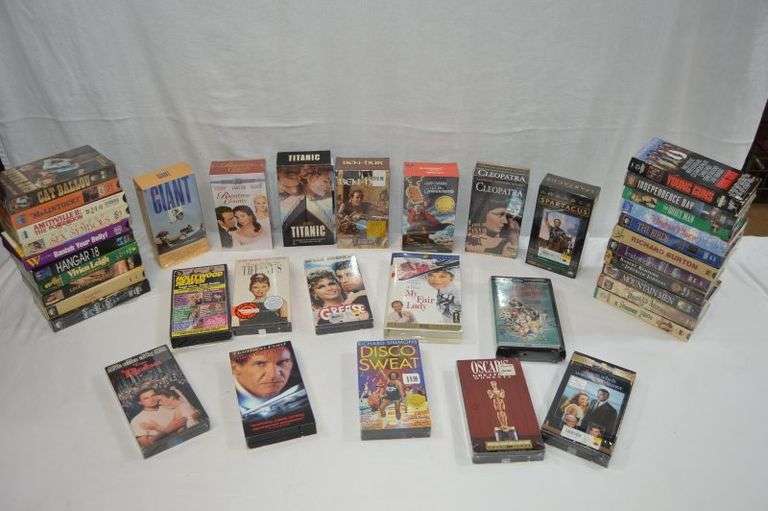 LARGE LOT OF ASSORTED VHS TAPES. A LOT OF THEM ARE NEW IN PACKAGING