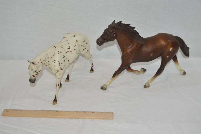 BREYER HORSES: THE BROWN ONE HAS A PIECE BROKE OFF THE TAIL, & THE WHITE ONE HAS PEN MARKS ON IT