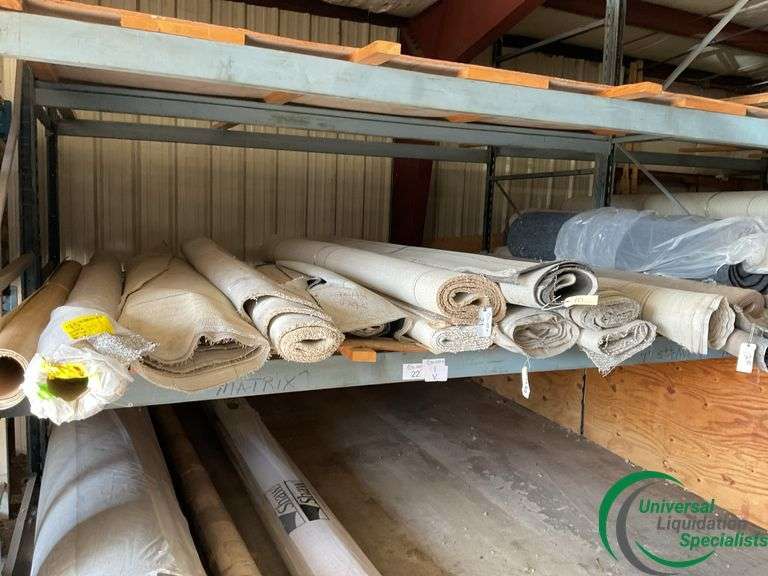 14 rolls of carpet and roll of vinyl