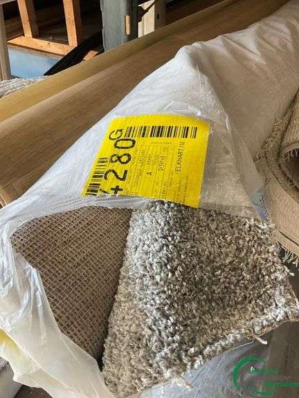14 rolls of carpet and roll of vinyl