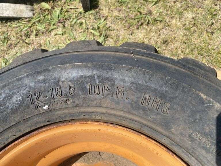 Skid steer wheel w/ tire 12-16.5 10PR, *Unreserved*