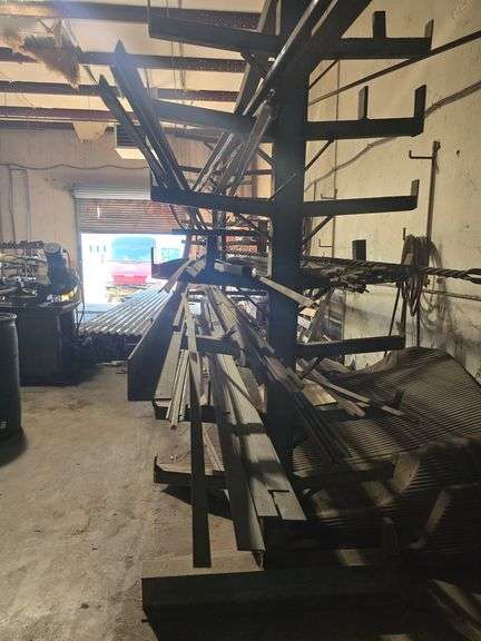 SOLID IRON STOCK PCS INCLUDING PRE TWISTED PIECES.. LONGEST PIECE IN LOT APROX 20'3" WITH ABOUT 30PCS TOTAL IN LOT WITH SOLID METAL MATERIAL STAND 9-TIER APROX 14'4" x 37" x 8'2" INCLUDED