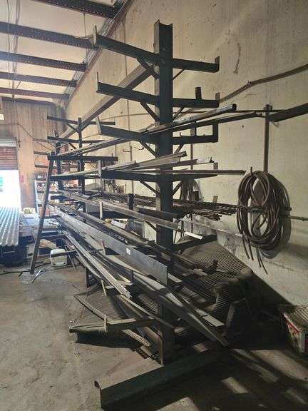 SOLID IRON STOCK PCS INCLUDING PRE TWISTED PIECES.. LONGEST PIECE IN LOT APROX 20'3" WITH ABOUT 30PCS TOTAL IN LOT WITH SOLID METAL MATERIAL STAND 9-TIER APROX 14'4" x 37" x 8'2" INCLUDED