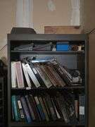 SOLID WOODEN BOOKSHELF APROX 35"x1'x7' WITH CONTENTS INCLUDING VARIOUS MANUALS, CATALOGS, AND OFFICE SUPPLIES