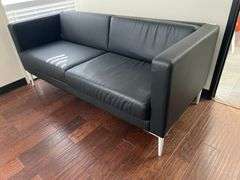 LEATHER-LIKE BLACK LOW COUCH APROX 6' x 32"x 30" WITH WHITE METAL LEGS
