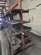 SOLID METAL MATERIAL ROLLING STAND APROX 6.5' x 39" x 5.5' WITH NUMEROUS METAL STOCK PCS INCLD.