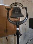 SOLID METAL STANDING BELL APROX 6'H