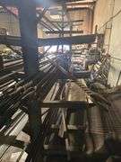 SOLID IRON STOCK PCS INCLUDING PRE TWISTED PIECES.. LONGEST PIECE IN LOT APROX 20'3" WITH ABOUT 30PCS TOTAL IN LOT WITH SOLID METAL MATERIAL STAND 9-TIER APROX 14'4" x 37" x 8'2" INCLUDED