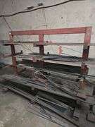 SOLID METAL MATERIAL ROLLING STAND APROX 6.5' x 39" x 5.5' WITH NUMEROUS METAL STOCK PCS INCLD.