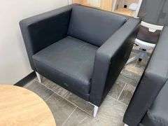 LEATHER-LIKE BLACK LOW LOUNGER APROX 32"SQ x 30"H WITH WHITE METAL LEGS