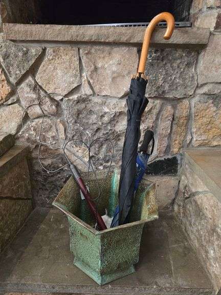 Vintage metal vase with rug beaters and umbrellas included