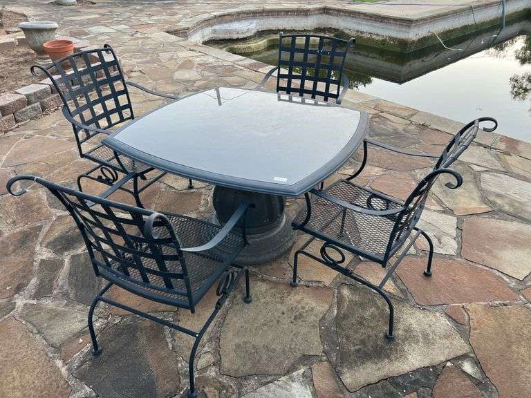 Dark metal outdoor table with four matching chairs.Table is about 44"sq X 28"H